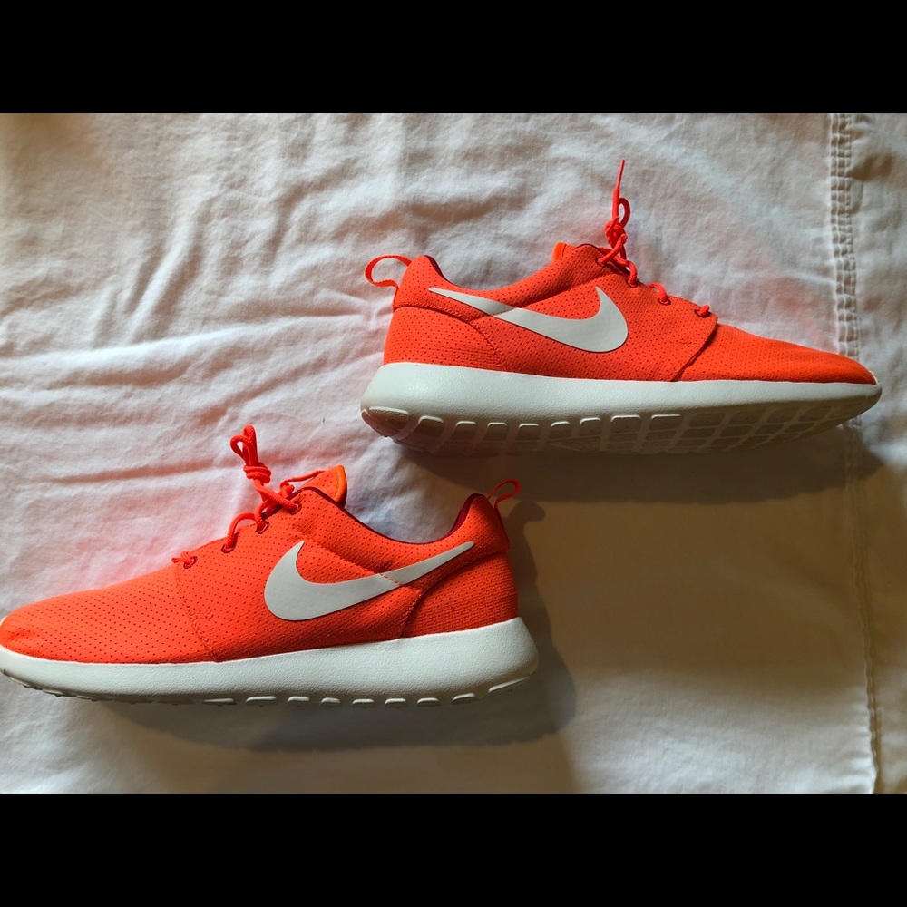 Orange and red Nike Roshe sneakers